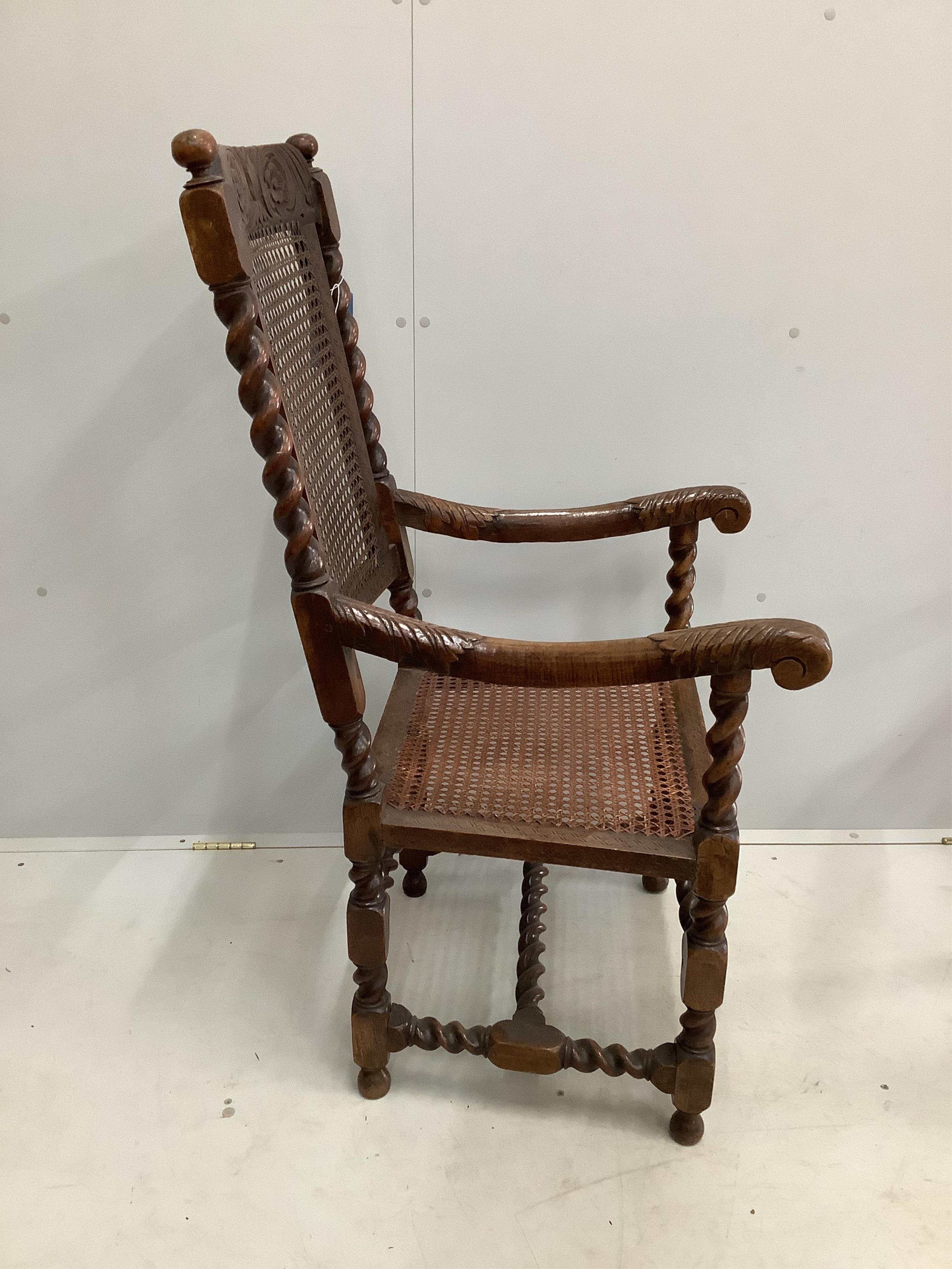 A William and Mary walnut and caned seat and back armchair, with a pierced scrolling crest rail and arched pierced front stretcher, width 56cm, depth 54cm, height 116cm. Condition - fair
